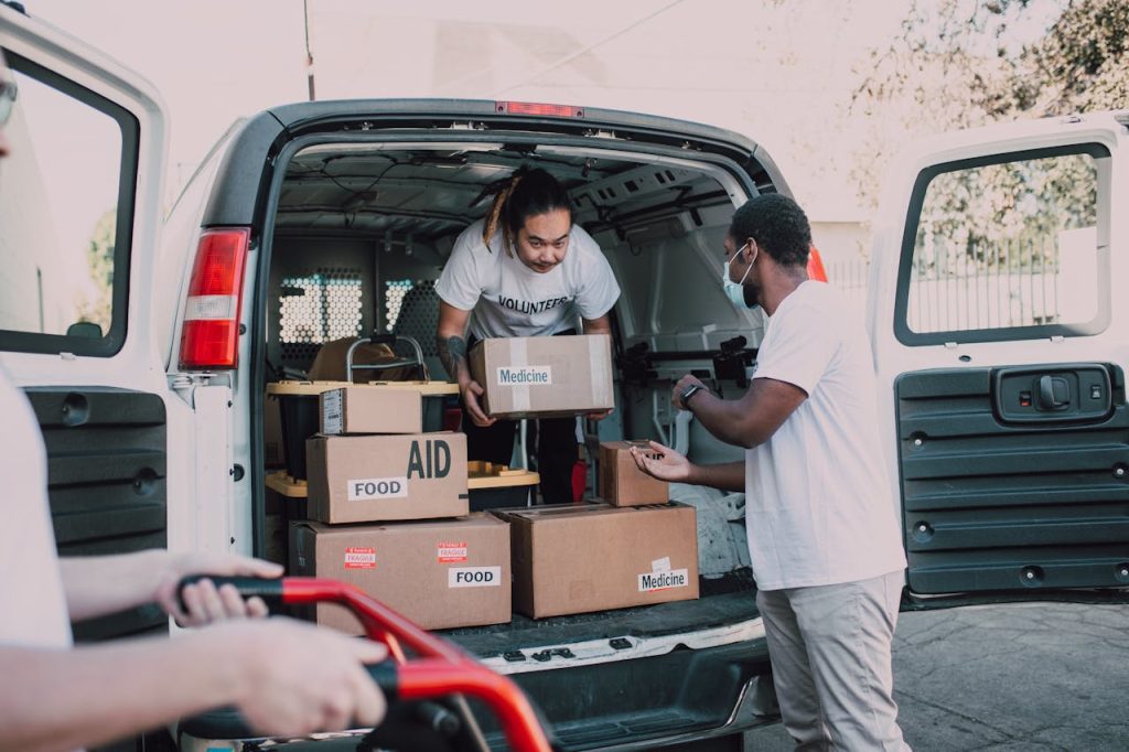 two-men-carrying-boxes-6647010 Two Men Carrying Boxes